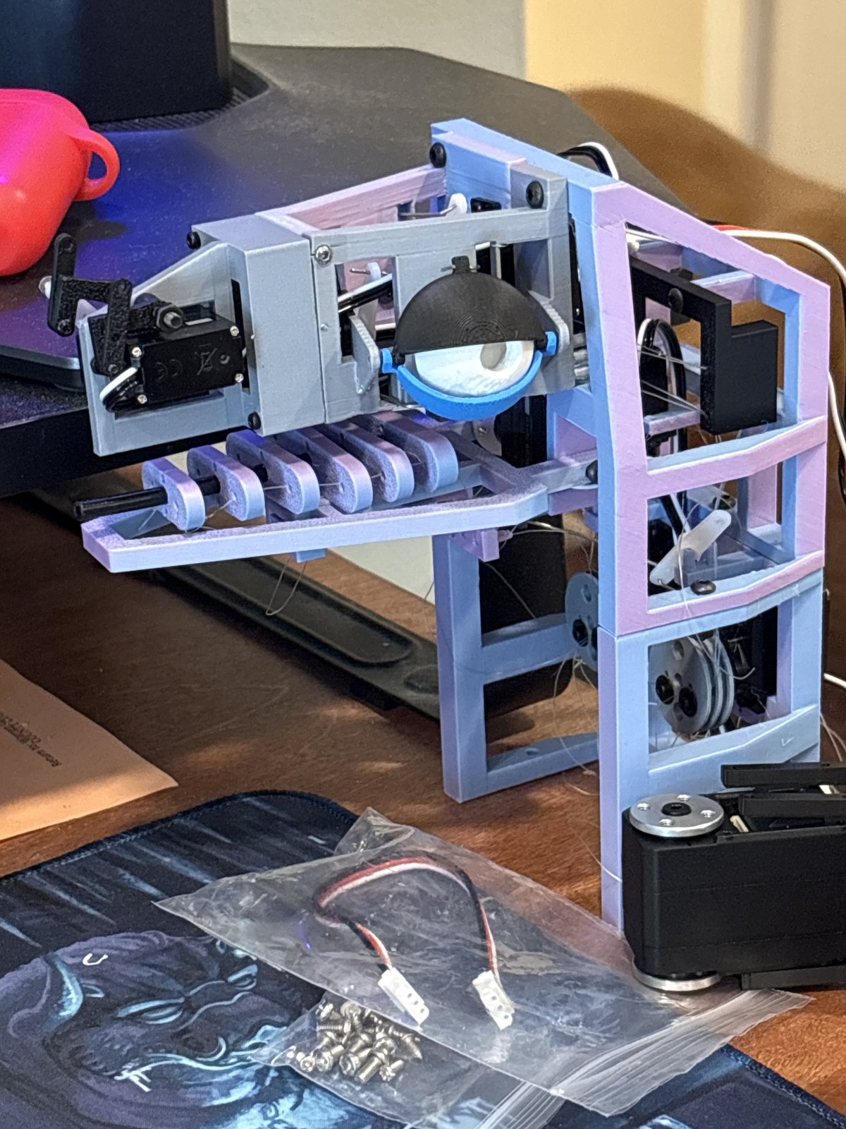 Current dragon head assembly from above, showing the eye, eyelid, jaw servo, and wiring